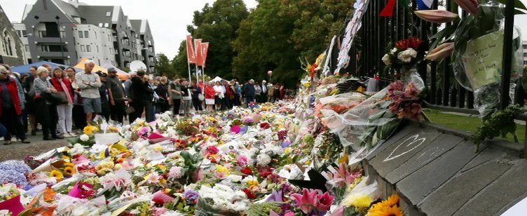 People lay flowers at a memorial for the mosque attack victims on Sunday in Christchurch, New Zealand.