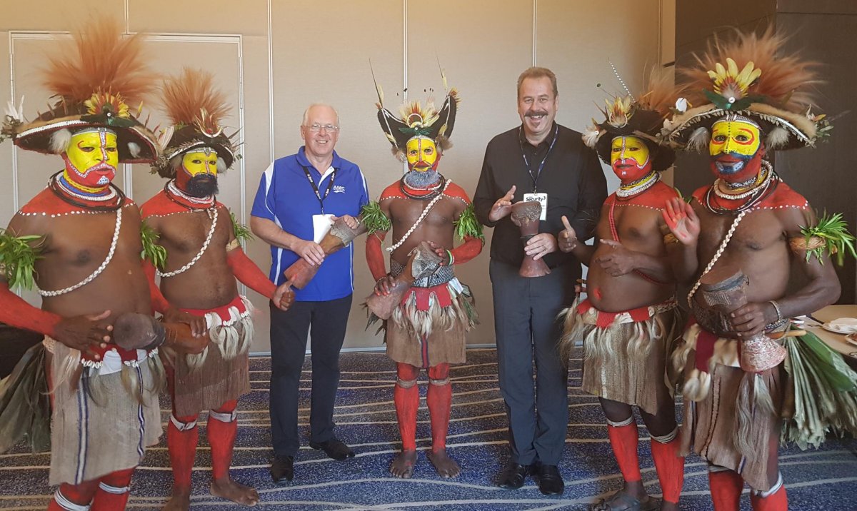 Richard Wilson, CEO of AARC Systems and Wayne Trethowan, General Manager of Consolidated Security Merchants being welcomed by PNG warriors in traditional dress