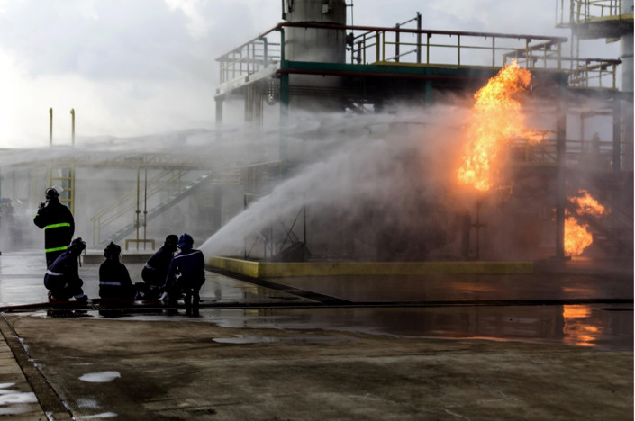 Firefighters combating fire at industrial site